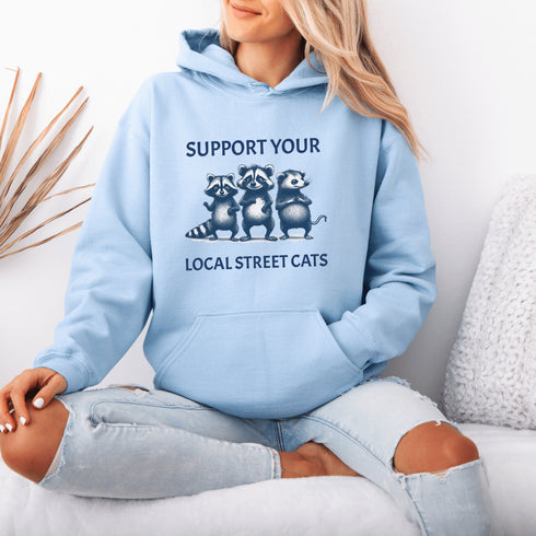 Nothing says “community support” like two raccoons and a possum banding together for the greater good (or maybe just snacks).